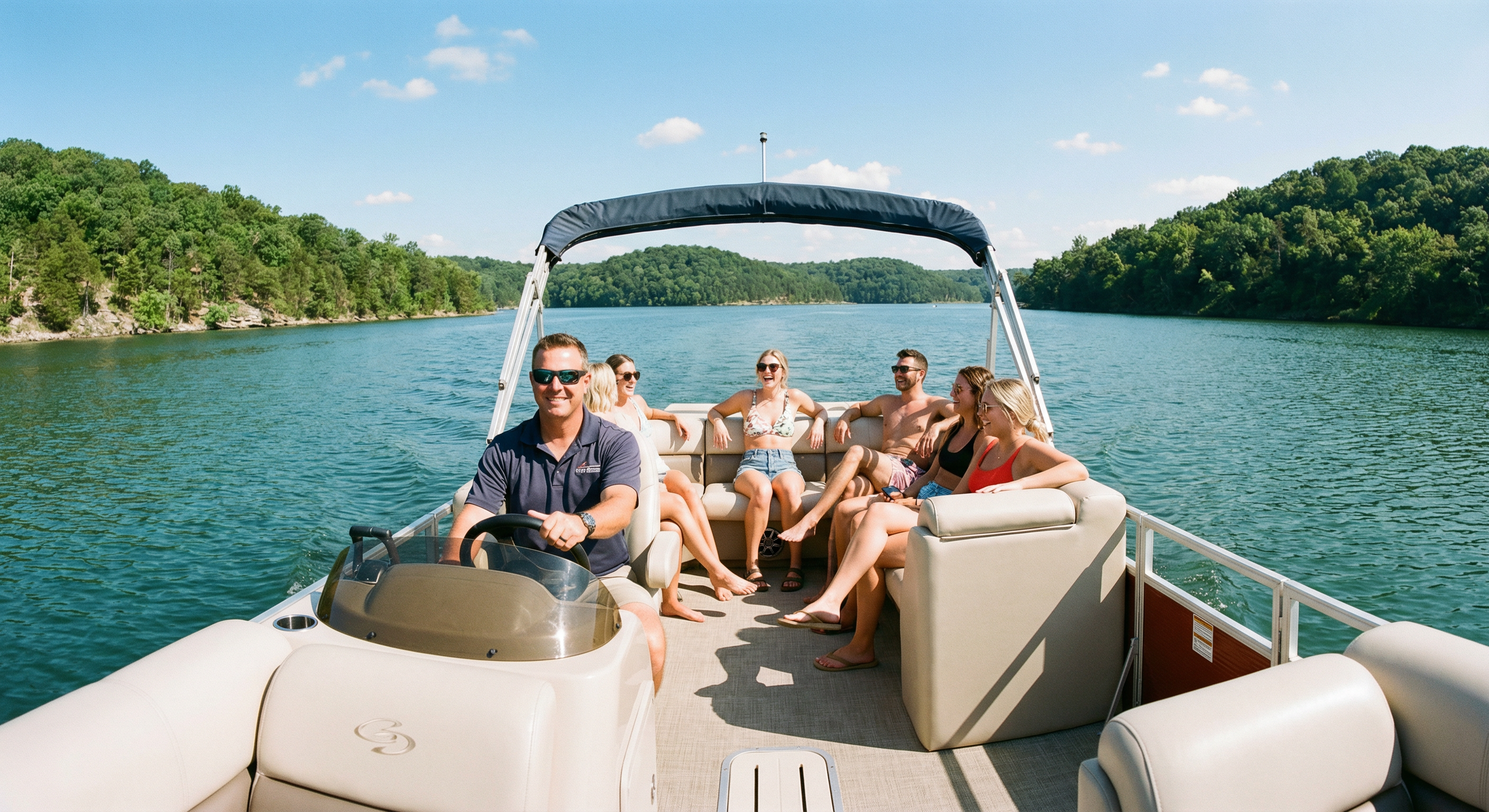 Captain steering a boat on Lake of the Ozarks